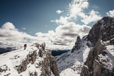 People on snowcapped mountain against sky