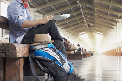 Low section of man waiting for train at railroad station