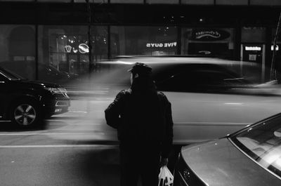 Blurred motion of people walking on road at night