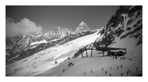 Panoramic view of snow covered mountain against sky