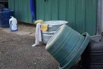 Garbage bins on road by wall