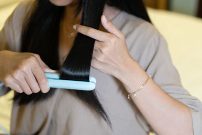 Midsection of woman using mobile phone