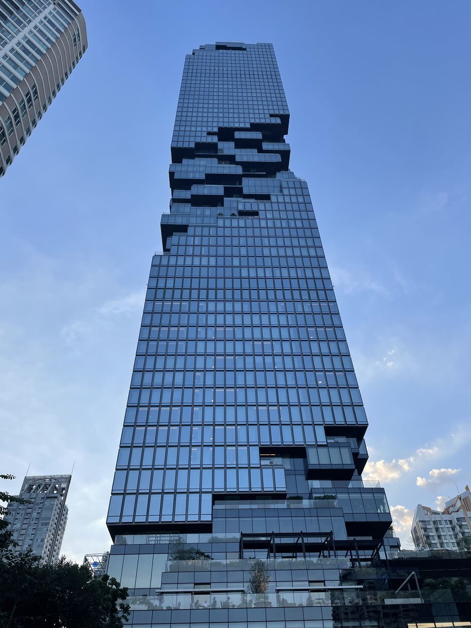 architecture, sky, building exterior, city, skyscraper, built structure, building, office building exterior, tower block, cloud, blue, nature, business, low angle view, landmark, office, day, communication, outdoors, no people, downtown, facade, urban area, sign