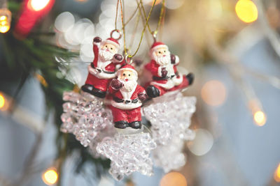 Santa claus doll hanging on christmas decoration tree