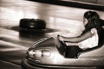 Side view of girl driving bumper car
