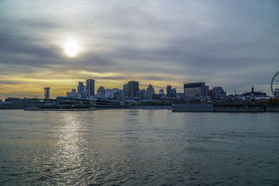 City at waterfront during sunset