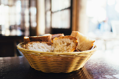 Close-up of breads in wicker basket on table