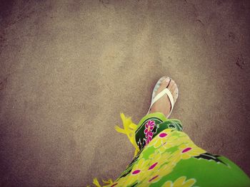 Low section of woman standing on tiled floor