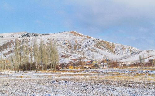 Scenic view of snowcapped mountains against sky