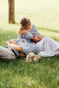 Couple lying on field