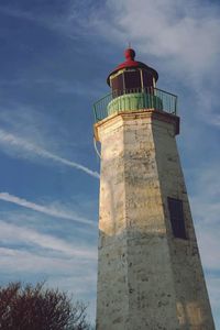 Low angle view of lighthouse against cloudy sky