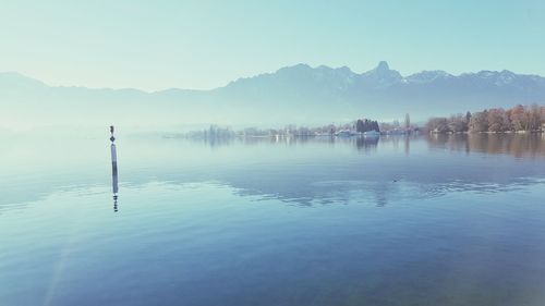 Scenic view of lake by trees against sky