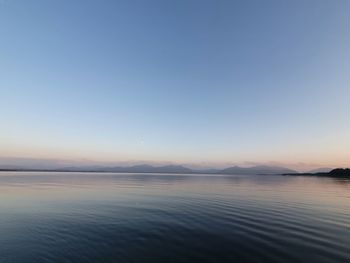 Scenic view of lake against clear blue sky