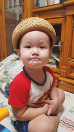 Cute baby girl sitting at home