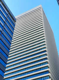 Low angle view of modern building against clear blue sky