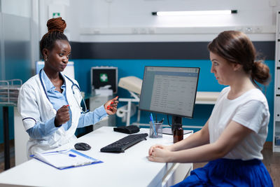 Doctor talking with patient in clinic