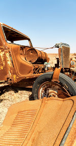 Abandoned car against clear sky