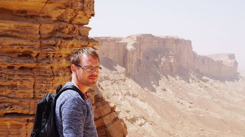 Portrait of a man against rocky landscape