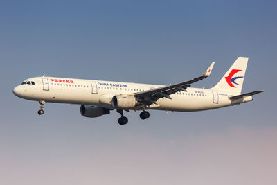 Airplane flying against clear blue sky