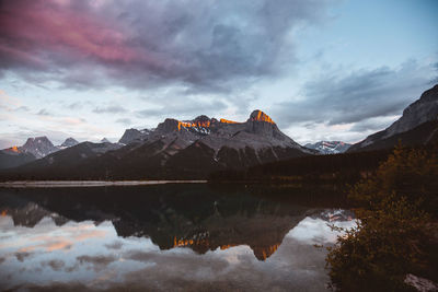 Scenic view of lake and mountains against sky during sunset