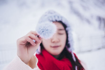 Close-up of woman holding fake fur during winter