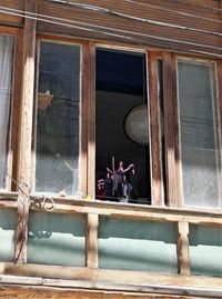 Low angle view of building seen through window