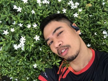 Portrait of young man against plants