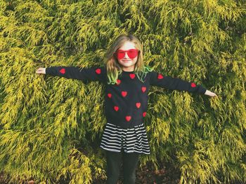 Portrait of smiling girl standing on field