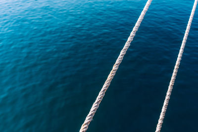 Close-up of rope against blue sea