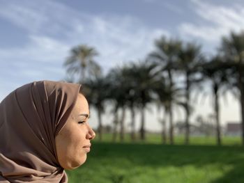 Portrait of muslim woman with palm trees