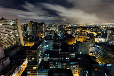 Illuminated cityscape against sky at night