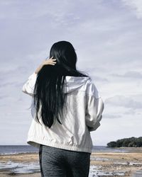 Woman on beach against sky