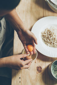 Cropped hands of person preparing food