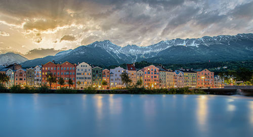 Scenic view of lake by buildings against sky