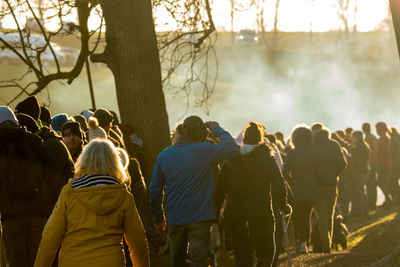 Rear view of people enjoying on land