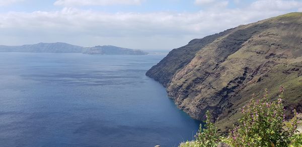 Scenic view of sea and mountains against sky