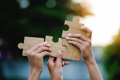 Cropped hand holding jigsaw pieces