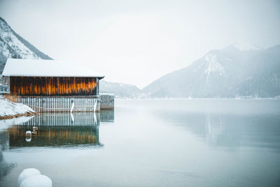 Scenic view of lake and mountains against sky