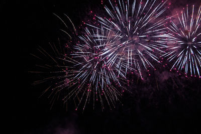 Low angle view of firework display at night