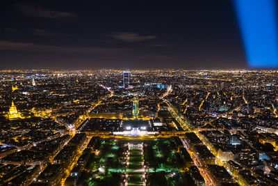 High angle view of city lit up at night