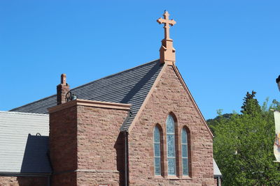 Low angle view of temple against clear blue sky