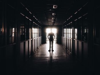 Rear view of silhouette man in tunnel