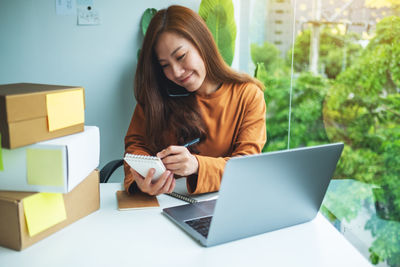 Young woman using laptop at home