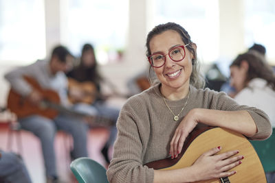 Music teacher during guitar lesson