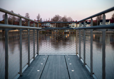 Bridge over canal in city against sky