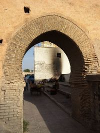 Archway in city against sky