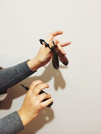 Cropped image of woman playing the finger cymbals