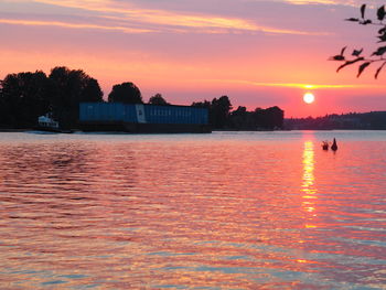 Scenic view of lake against orange sky