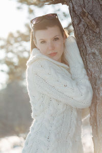 Portrait of woman with snow covered tree