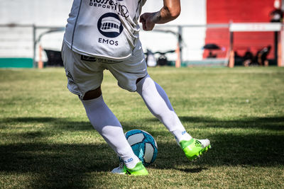 Low section of woman with ball on field